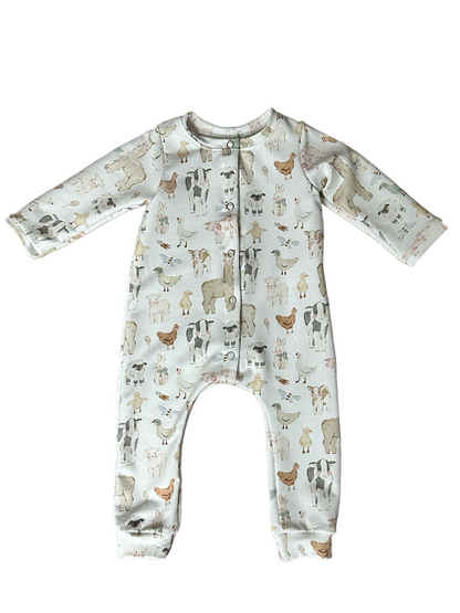 Baby onesie with farmyard pattern on a white background