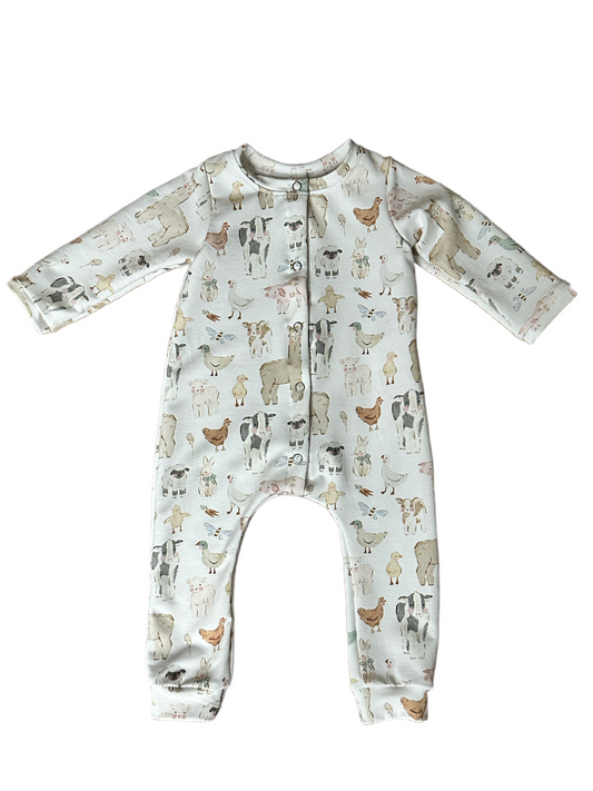 Baby onesie with farmyard pattern on a white background