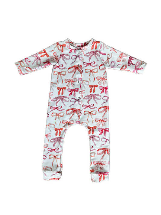 Baby onesie with bow pattern on a white background