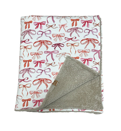 Fleece baby blanket featuring a charming bows design