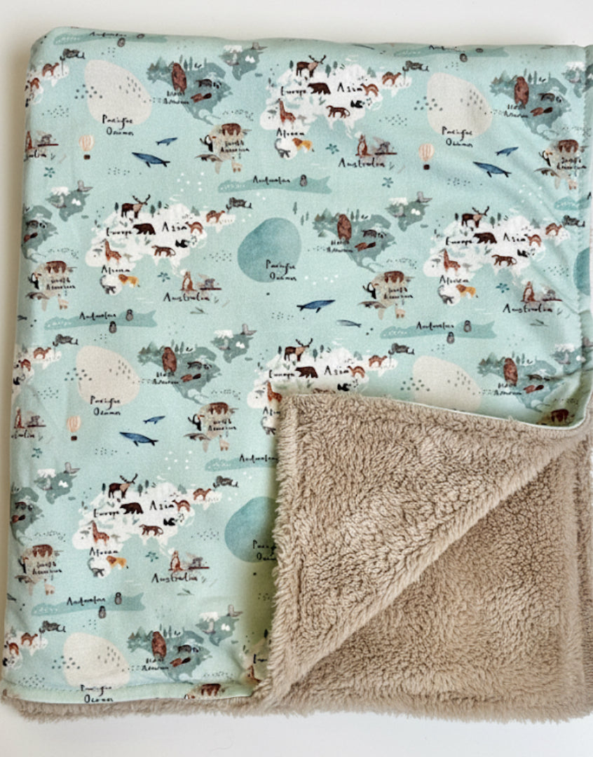 Fleece baby blanket featuring a world map design