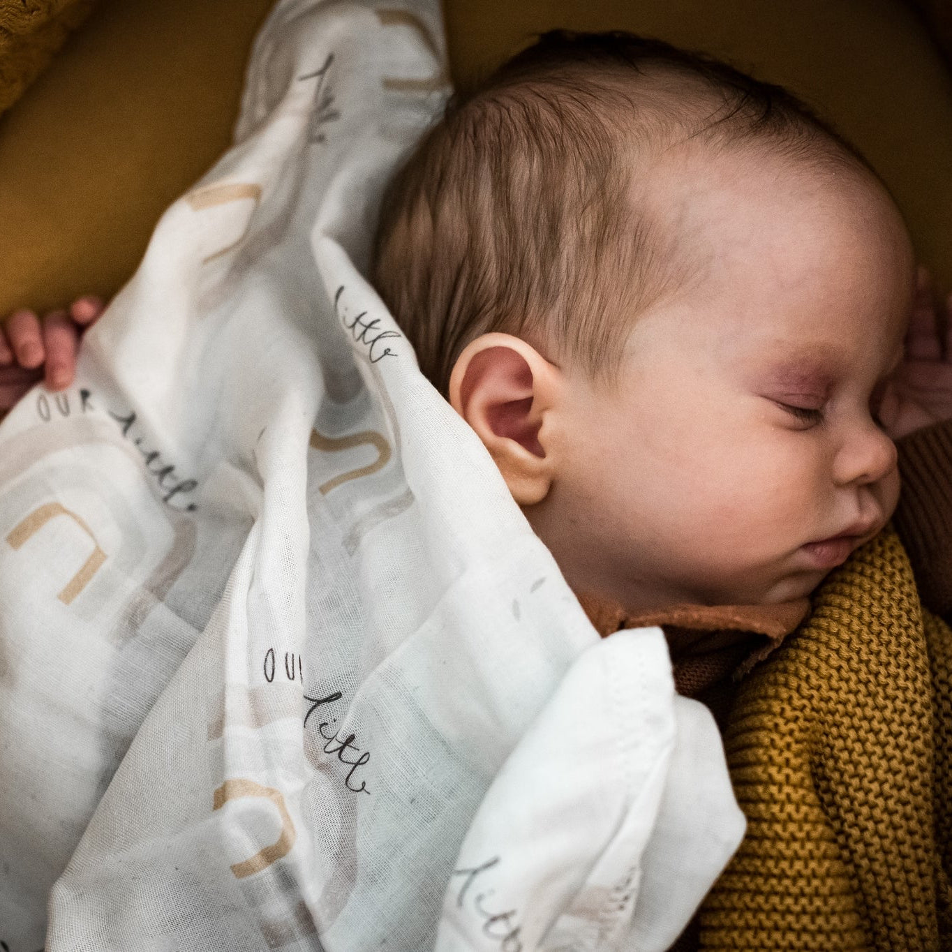 baby under a white cotton muslin