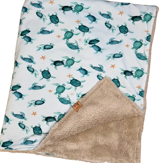 Fleece baby blanket featuring a turtle pattern