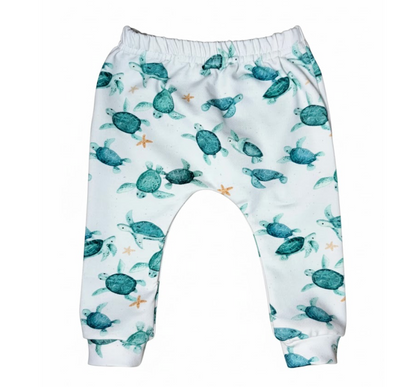 Baby leggings with turtle pattern on a white background