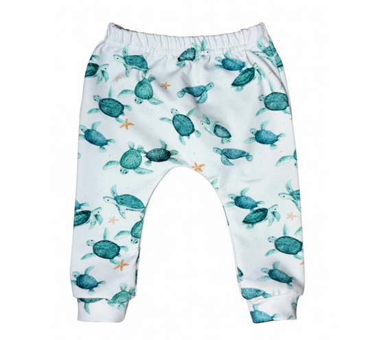 Baby leggings with turtle pattern on a white background